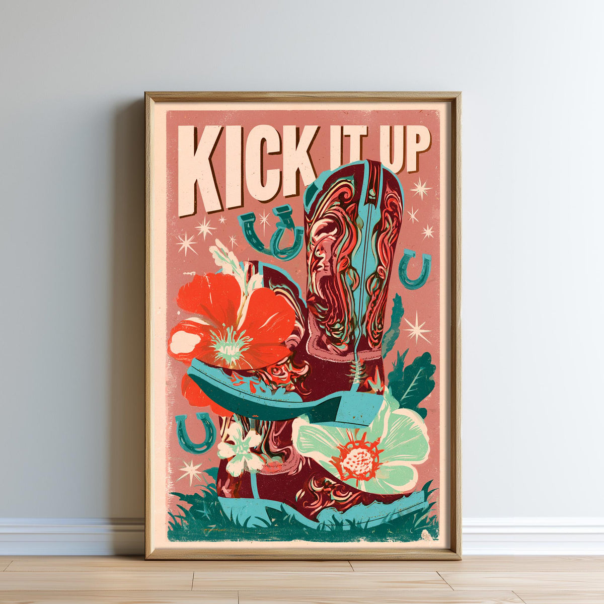 The image is a framed poster with a vibrant, colorful design featuring cowboy boots, flowers, and the text "KICK IT UP" prominently displayed.