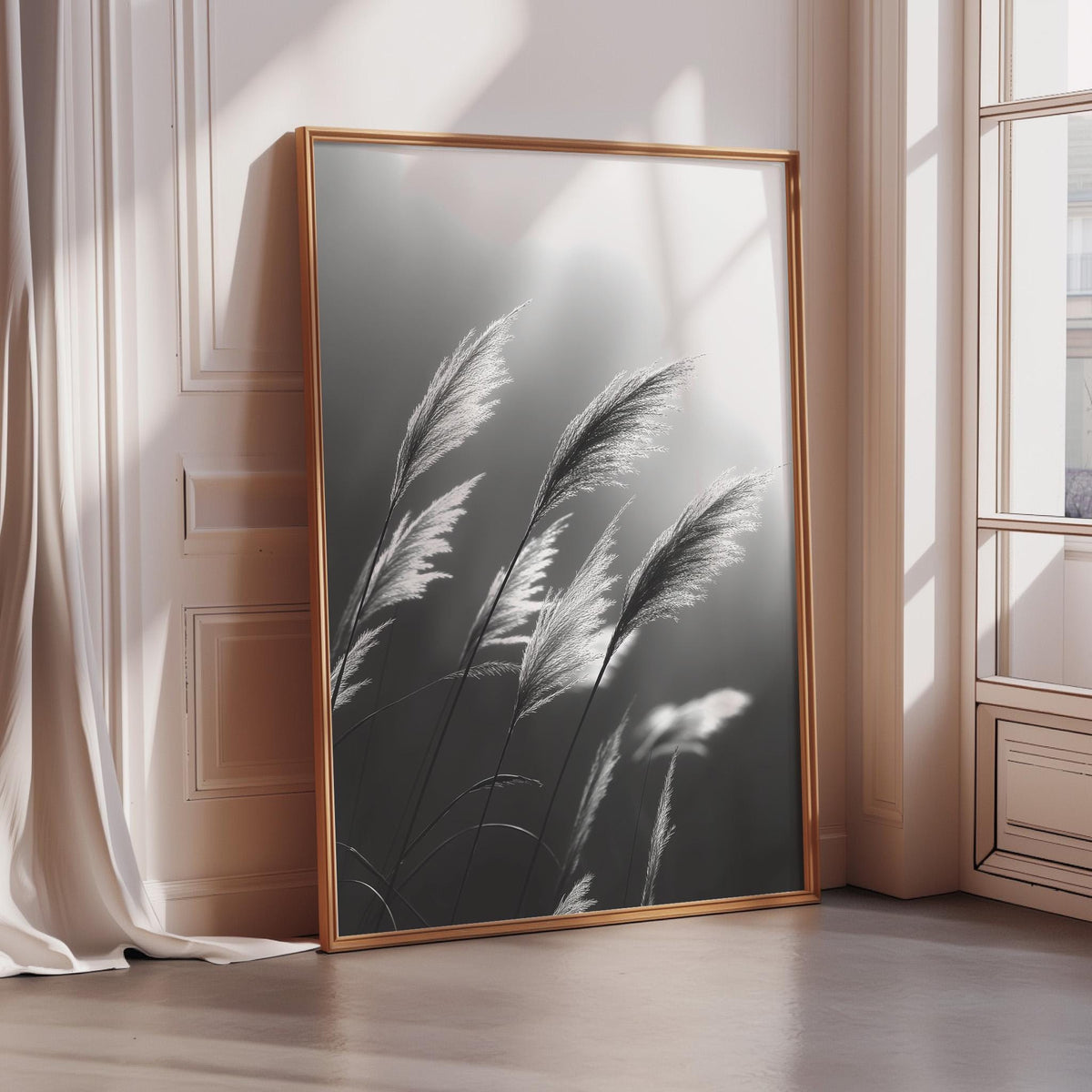 a large framed photograph of tall grasses with long, thin leaves, set against a white wall and a window.