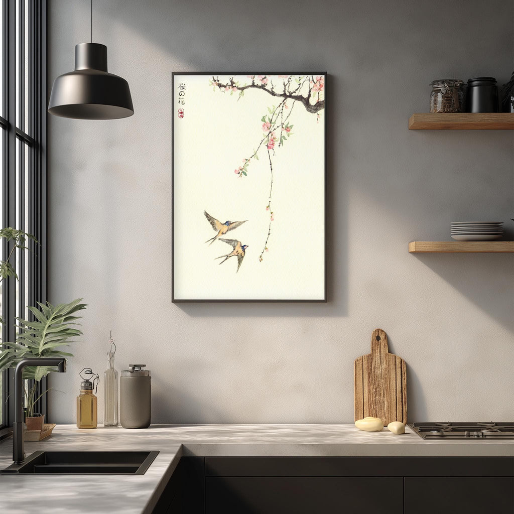a kitchen counter with a framed picture of two birds, a wooden cutting board, and various kitchen items such as a bottle, a can, and a bowl.