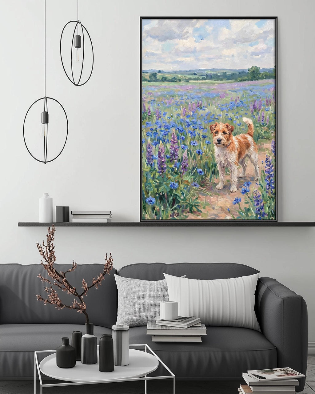 a large painting of a dog in a field of flowers hanging on a wall above a gray couch with a coffee table in front of it.