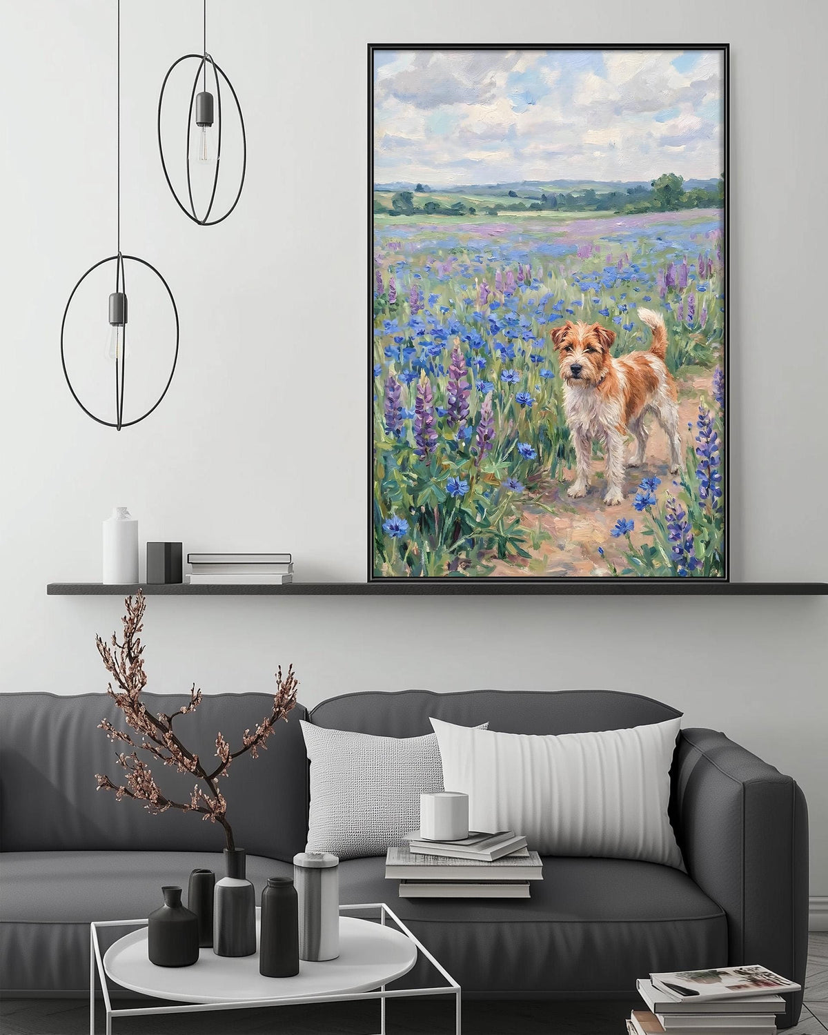 a large painting of a dog in a field of flowers hanging on a wall above a gray couch with a coffee table in front of it.