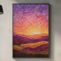 a kitchen counter with a framed painting of a sunset landscape hanging above it. The painting has a vibrant, colorful design with a warm, golden glow. The kitchen counter also has various items such as a cutting board, a bottle, and a vase.