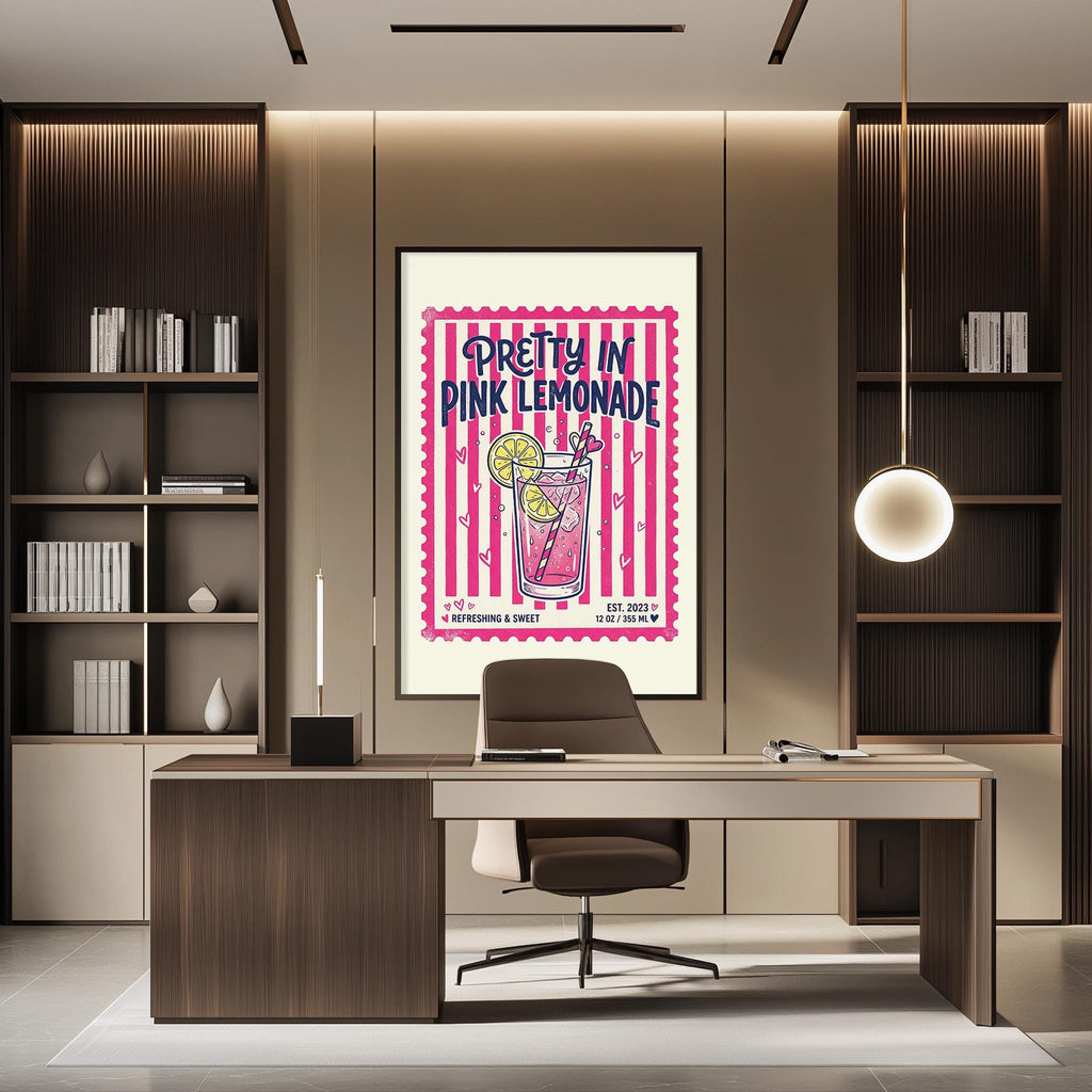 a modern office space with a large framed poster of a pink lemonade drink hanging on the wall. The poster has a pink and yellow color scheme and includes a stylized illustration of a lemonade glass. The office has a wooden desk and chair, and there are bookshelves on either side of the desk. The overall design of the space is contemporary and visually appealing.