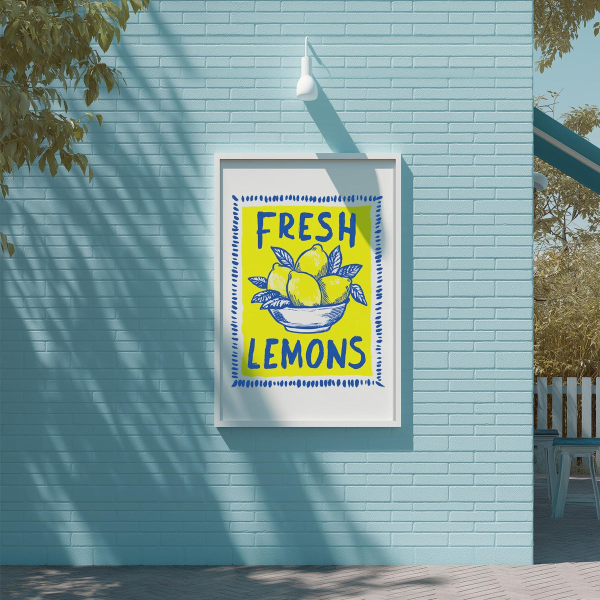 A framed sign on a blue wall that reads "FRESH LEMONS".