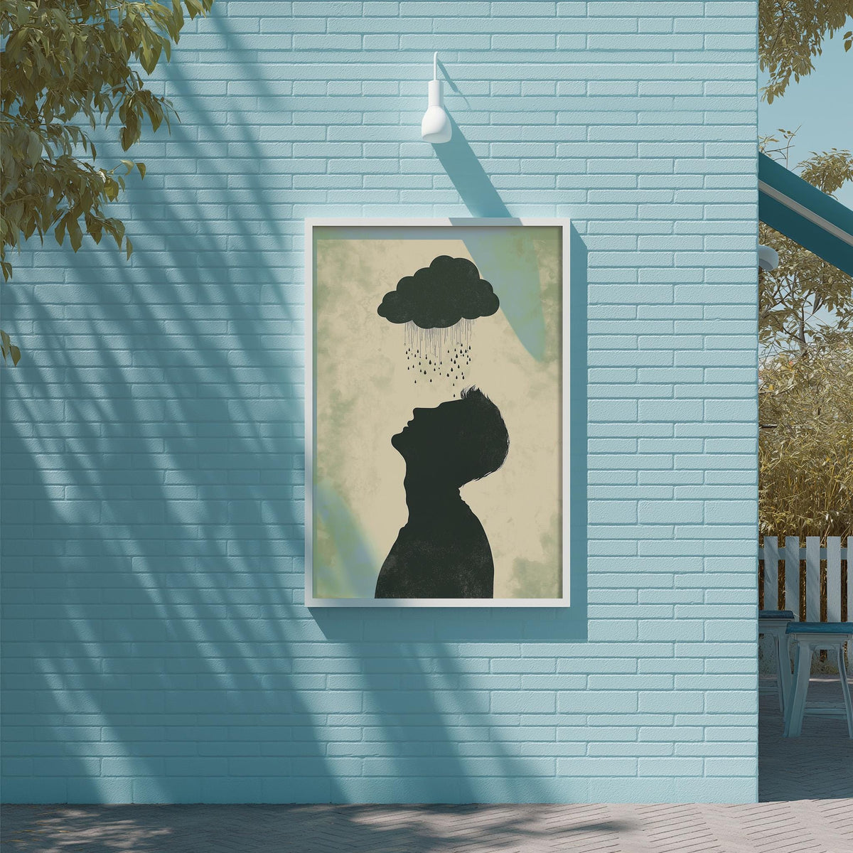 a blue brick wall with a framed artwork depicting a silhouette of a person looking up at a cloud of rain.